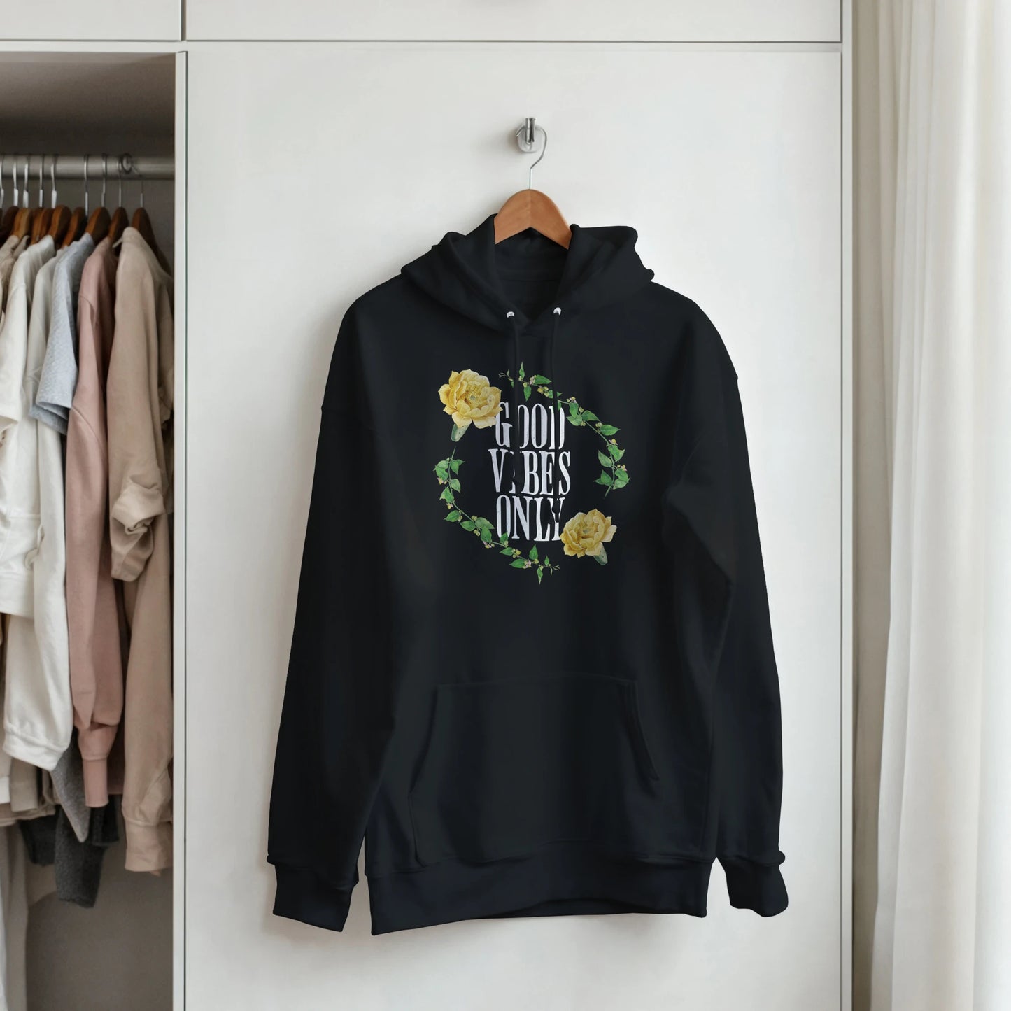 Black men's hoodie with Good Vibes Only text inside a yellow rose wreath, front pouch pocket, cotton-poly blend.