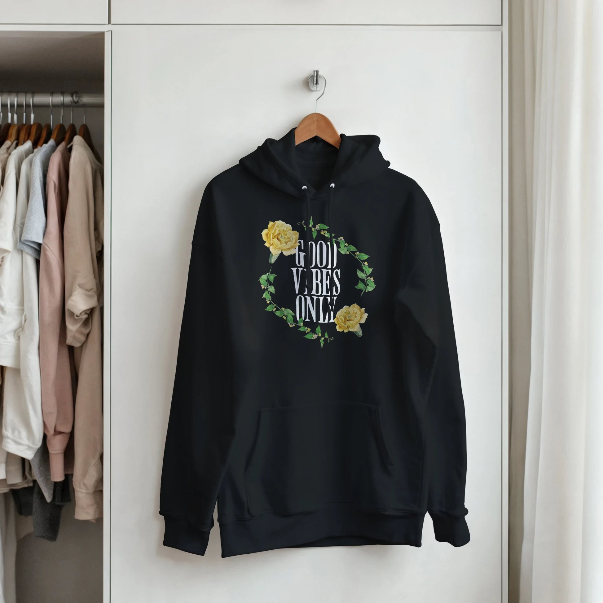 Black men's hoodie with Good Vibes Only text inside a yellow rose wreath, front pouch pocket, cotton-poly blend.