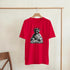 Red men's T-shirt with Statue of Liberty as DJ on a turntable graphic.