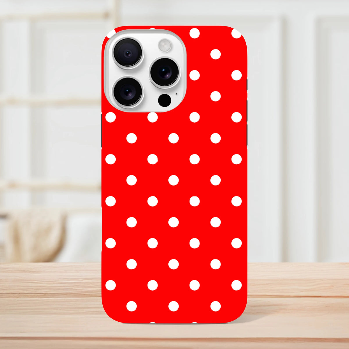 Red and white polka dot iPhone case featuring a tough dual-layer TPU design for drop protection on models 13 through 16.