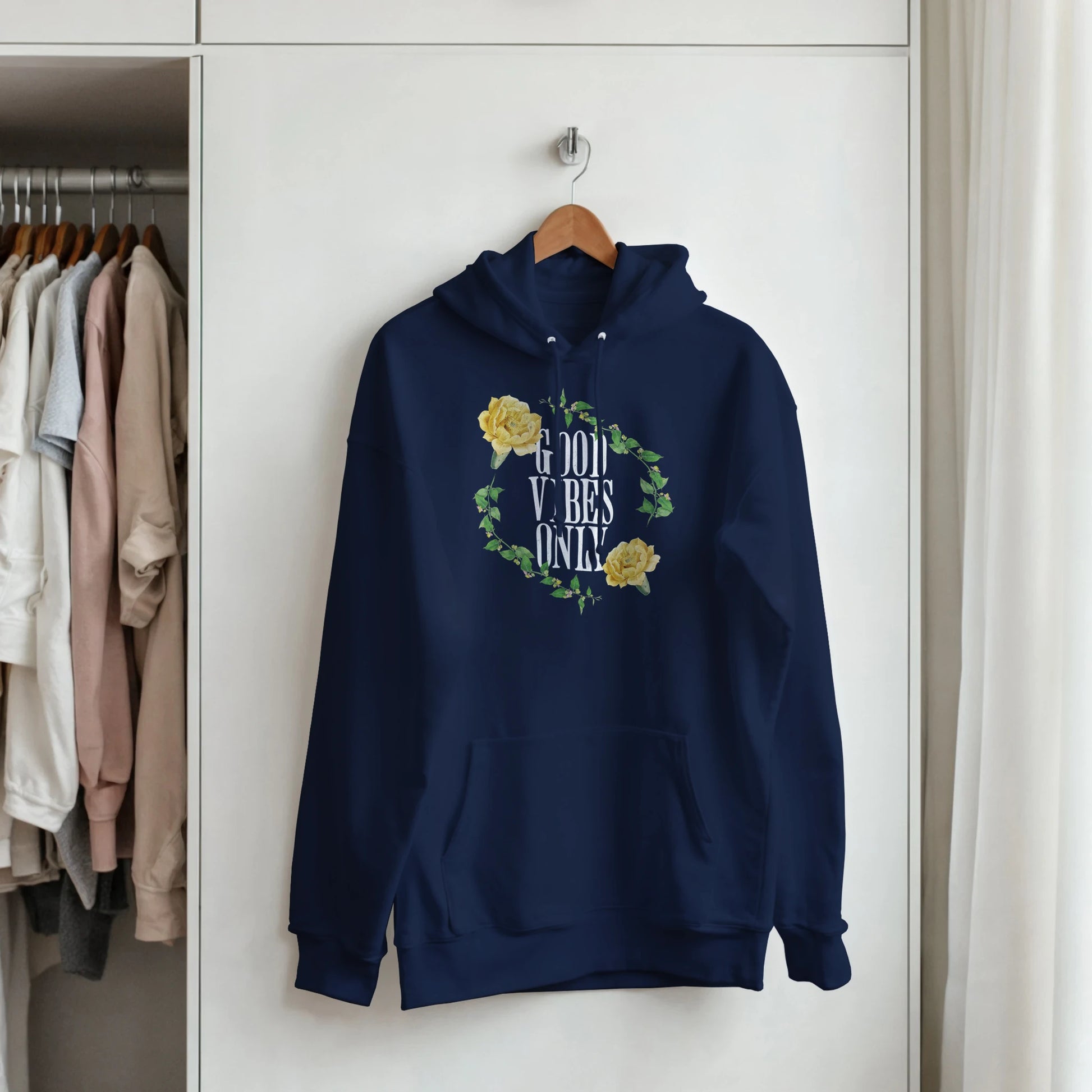 Navy women's graphic hoodie with a circular ivy and yellow rose motif surrounding GOOD VIBES ONLY and a front pocket.