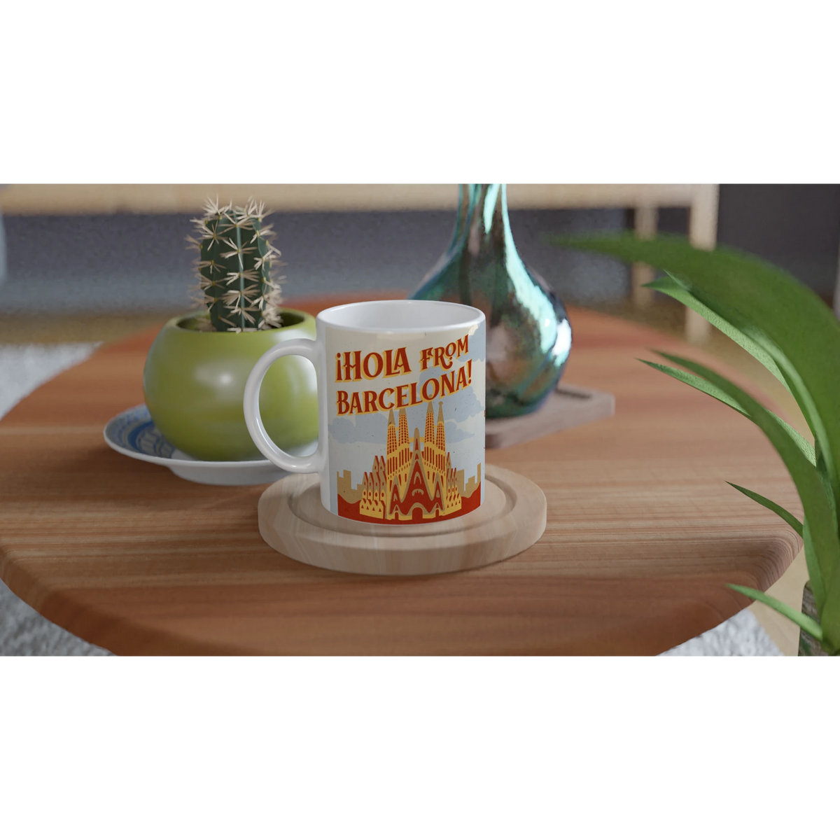 Vintage Barcelona mug with 'Hola from Barcelona' postcard design on a wooden table beside a cactus.