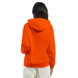 Back view of a vintage orange pullover hoodie featuring a relaxed fit and hood, styled with light denim for streetwear.