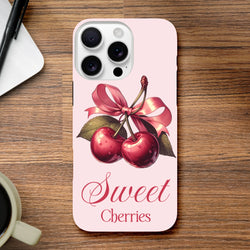 Vintage style iPhone case featuring red cherries tied with a pink bow and Sweet Cherries text on a pale pink background.