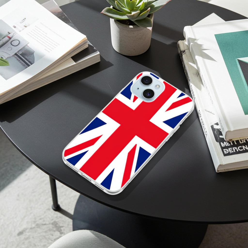 Phone case with British flag design on a black table with books and a plant.