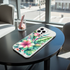 Phone case with floral design on a table near a window