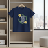 Navy blue t-shirt with 'Good Vibes Only' text and flowers on a hanger in a room with a city view.