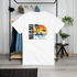 White t-shirt with 'Miami' design hanging on a rack in a room.