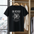 Black t-shirt with 'OUTCAST' design hanging in a wardrobe.