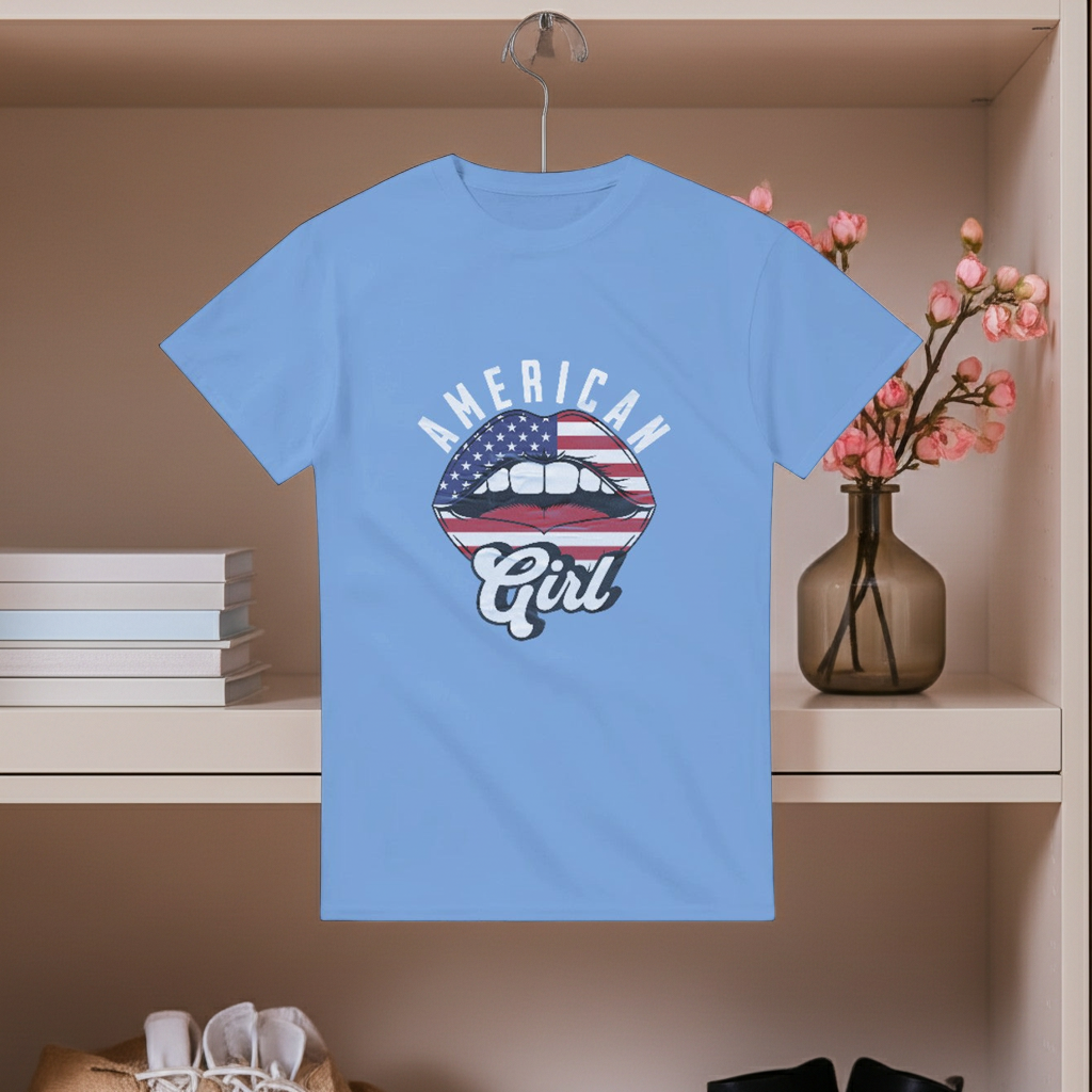 Blue t-shirt with 'American Girl' graphic on a hanger against a neutral background