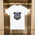 White t-shirt with a colorful dog graphic on a wooden hanger against a wooden background