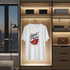 White t-shirt with red and black graphic design hanging in a modern wardrobe.
