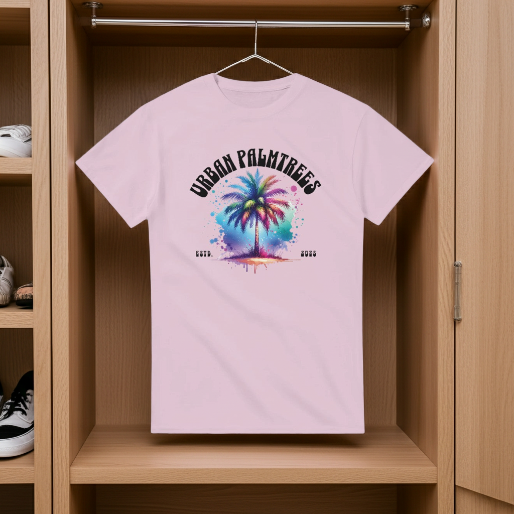 Pink t-shirt with colorful palm tree design hanging in a wooden wardrobe.