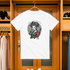 White t-shirt with a graphic design hanging in a wardrobe.