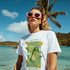 Model wearing white Lemons graphic T-shirt with lemon print; soft cotton blend, sizes S to XL, blue pink black.