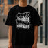 Black men's mental health graphic T-shirt with bold white phrase Quit thinking solved nothing worn by a man.