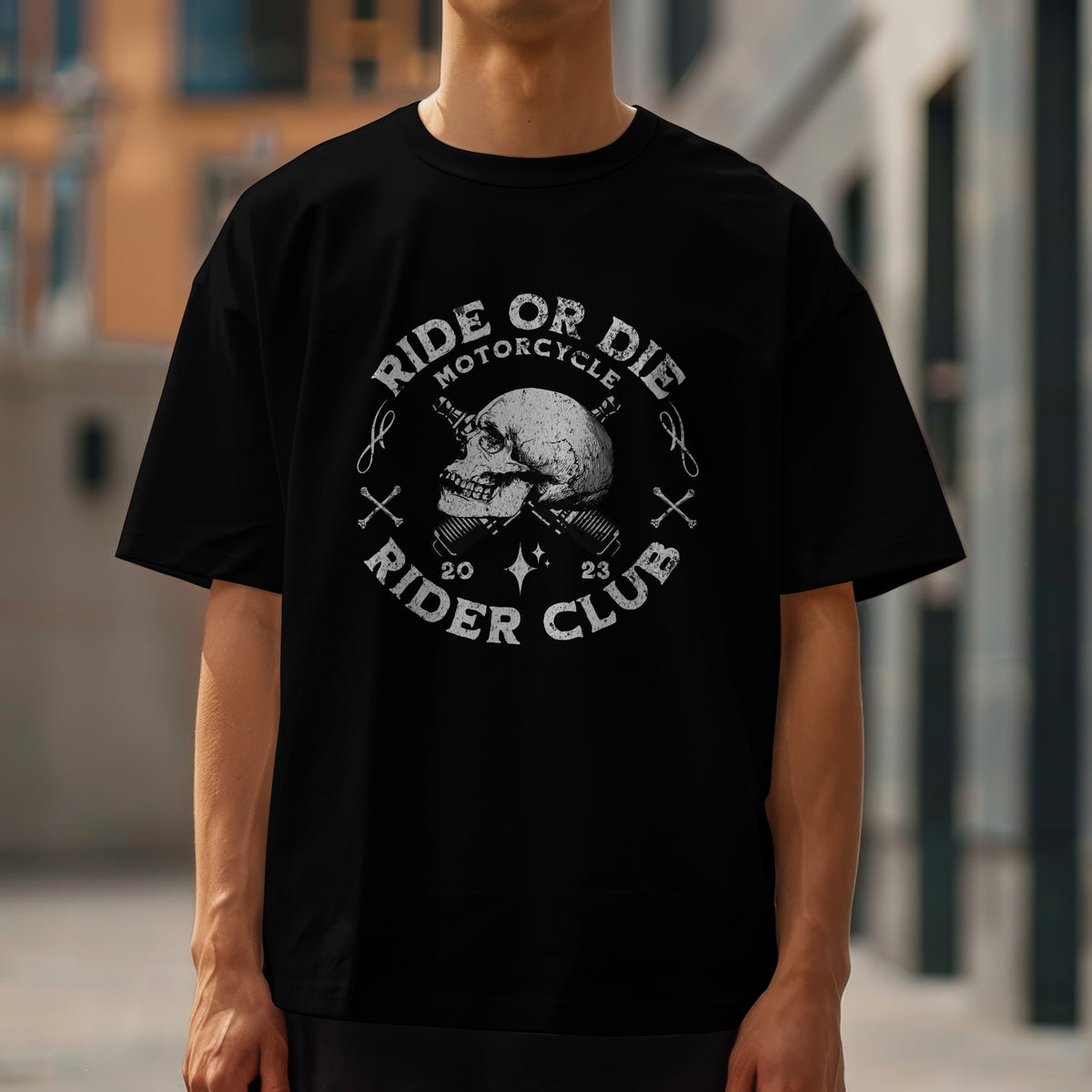 Man wearing black Motorcycle Club graphic T-shirt with skull emblem and ride‑or‑die text.