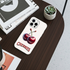 Phone case with cherry design on a wooden surface