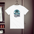 White t-shirt with 'Summer Beach' design on a hanger against a wooden wardrobe background.