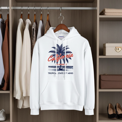 White hoodie with palm tree design hanging in a wardrobe