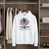 White hoodie with palm tree design hanging in a wardrobe