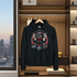 Black hoodie with a graphic design hanging in a wardrobe with cityscape view