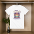 White t-shirt with a colorful graphic design hanging on a wooden rack.