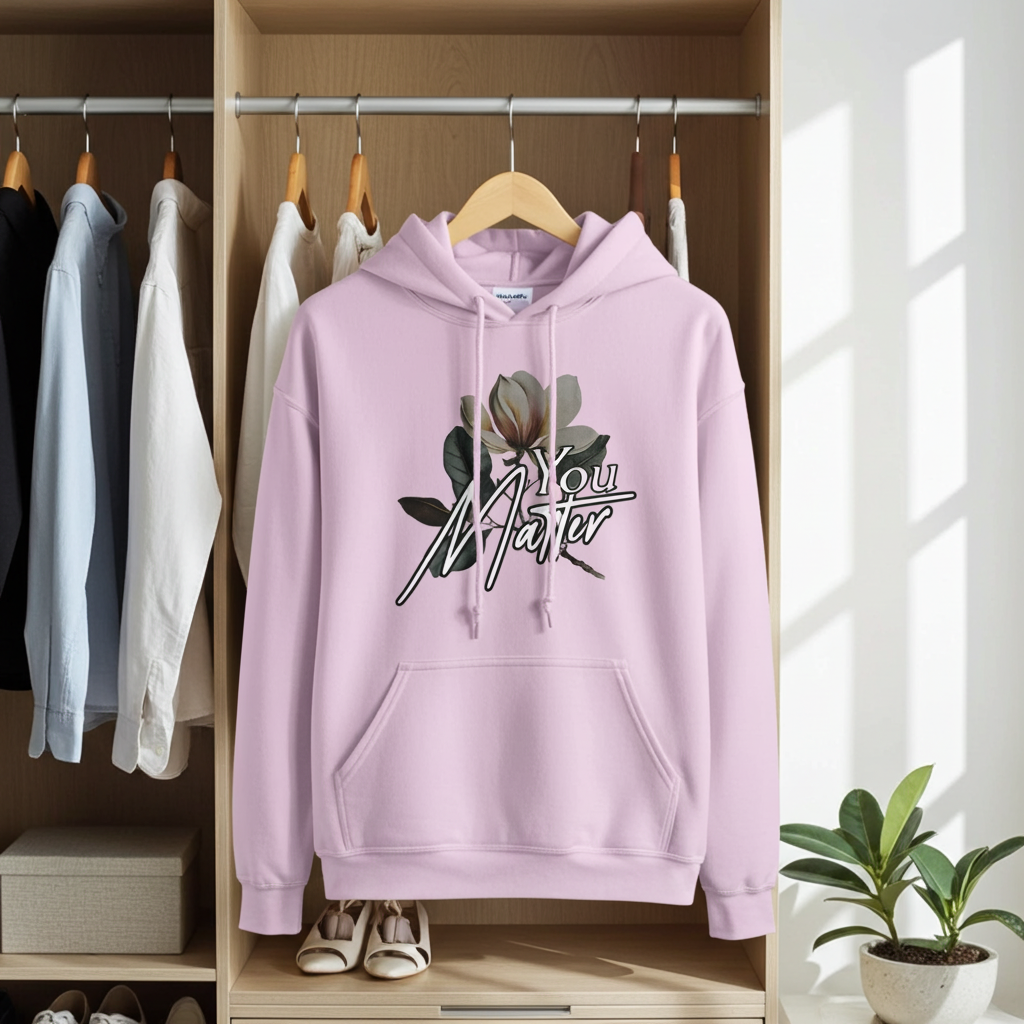 Pink hoodie with floral design and 'You Matter' text hanging in a wardrobe.