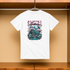 White t-shirt with a 'Sakura' design on a wooden surface