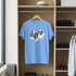 Blue t-shirt with 'Hype' print hanging in a closet.
