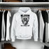 White hoodie with graphic design on a rack of clothes