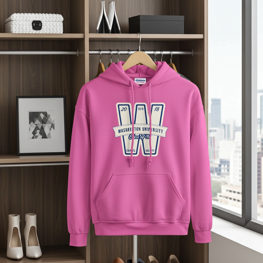 Pink hoodie with a logo on a hanger in a room with shelves and a window.