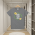 Gray t-shirt with 'Good Vibes Only' text and yellow flowers on a hanger in a modern closet.