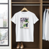 White t-shirt with graphic design hanging in a wardrobe.