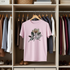 Pink t-shirt with floral design and text in a wardrobe setting