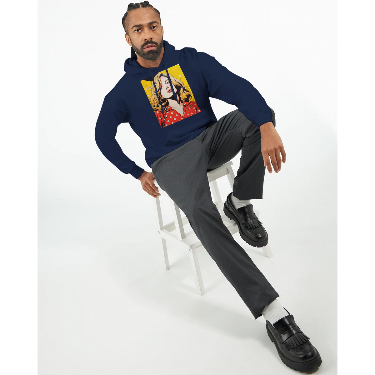 Man wearing navy vintage pop art woman hoodie with retro graphic, styled with grey trousers and black loafers for streetwear look.