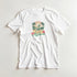 White women's tee with tropical surf graphic: surfer on a wave, palm trees, hibiscus, and sunset.