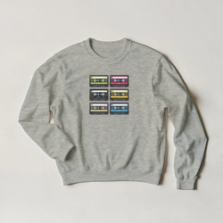 Grey crewneck sweatshirt featuring a vintage 90s cassette tape graphic in six colorful layouts for retro streetwear style.