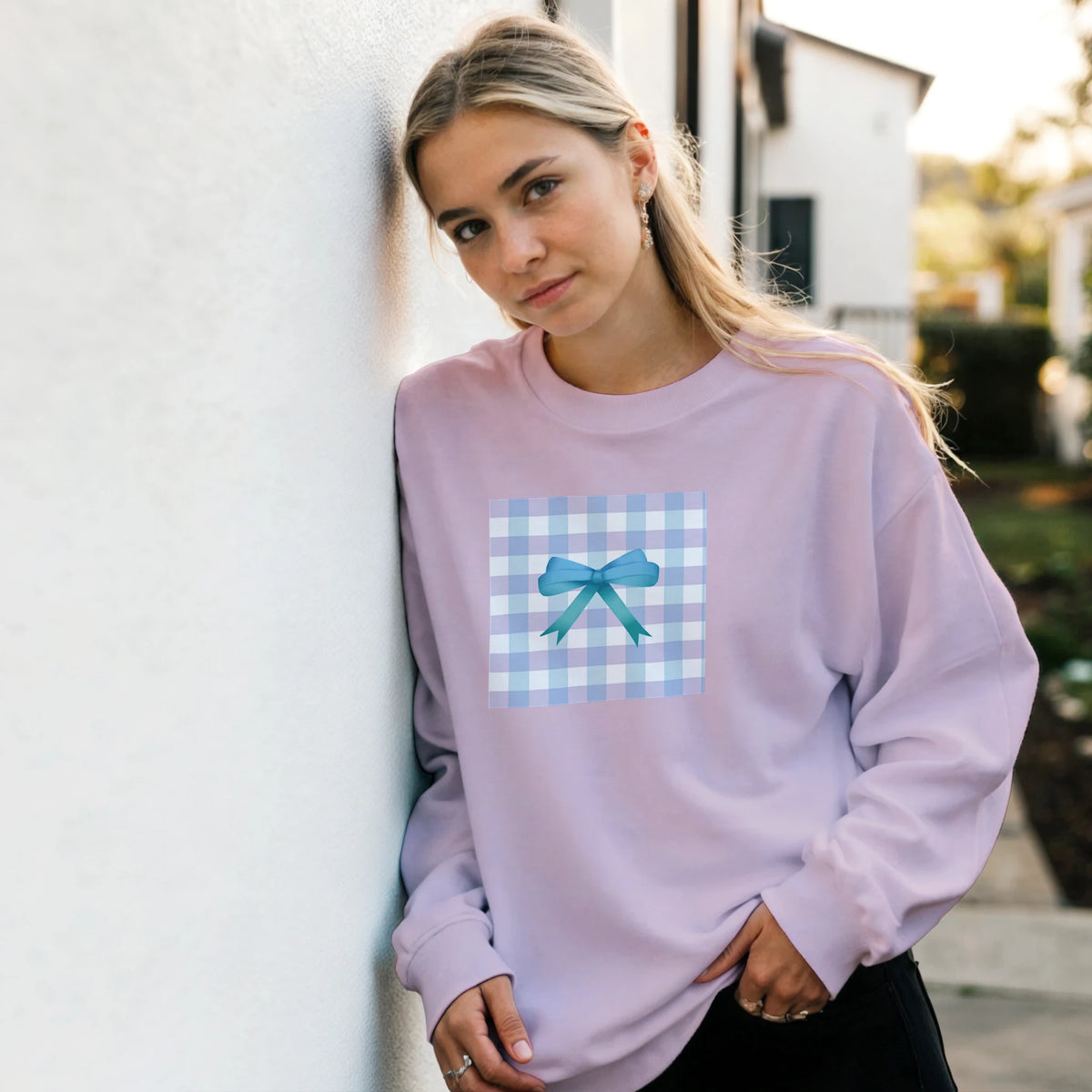 Lavender pullover sweatshirt featuring a blue gingham square graphic with a teal bow, embodying coquette streetwear aesthetic.