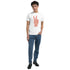 Male model wearing white Peace T-shirt with pink peace-sign design; heavyweight cotton blend, casual wear.