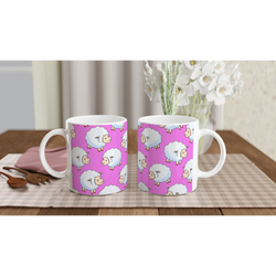 Three pink sheep-pattern ceramic mugs with white handles on a wooden table.