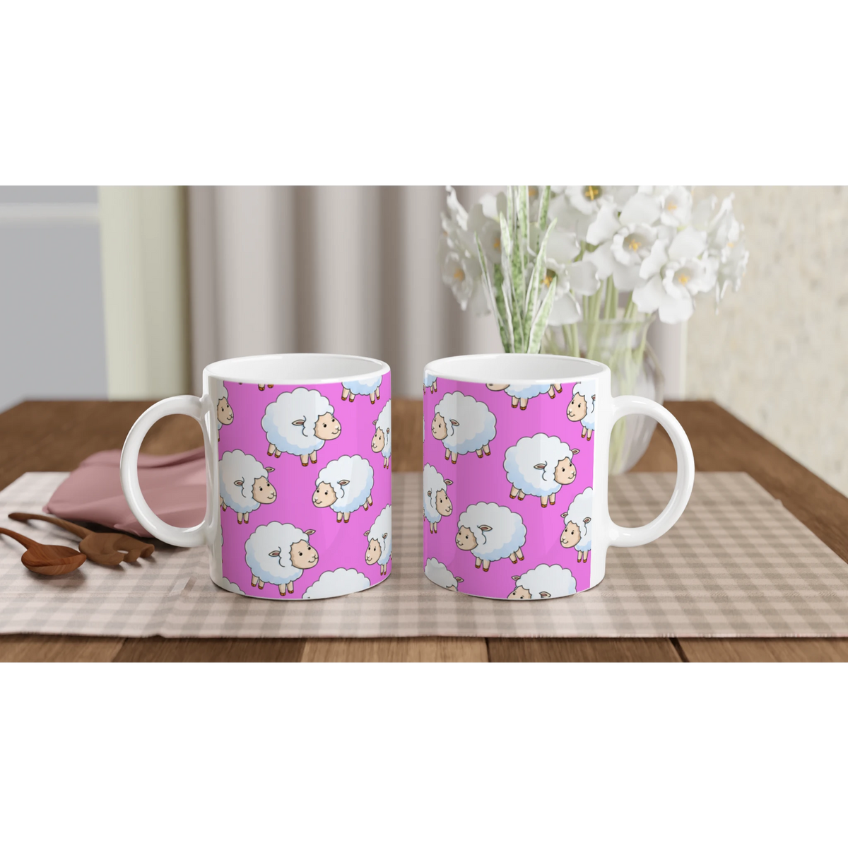 Three pink sheep-pattern ceramic mugs with white handles on a wooden table.