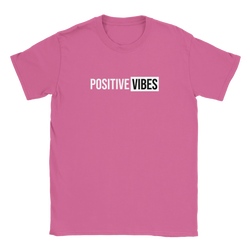 Pink women's T-shirt with bold 'POSITIVE VIBES' graphic in white blocks, retro streetwear vibe.
