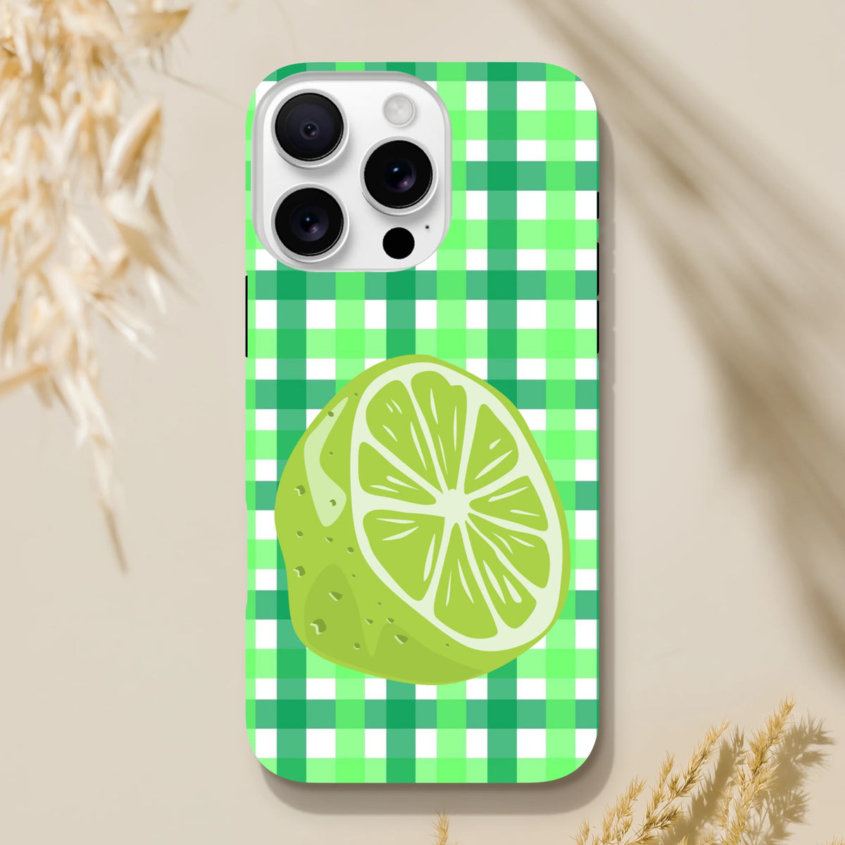 Lime green gingham iPhone case featuring a large citrus slice illustration and tough protective design for daily use.