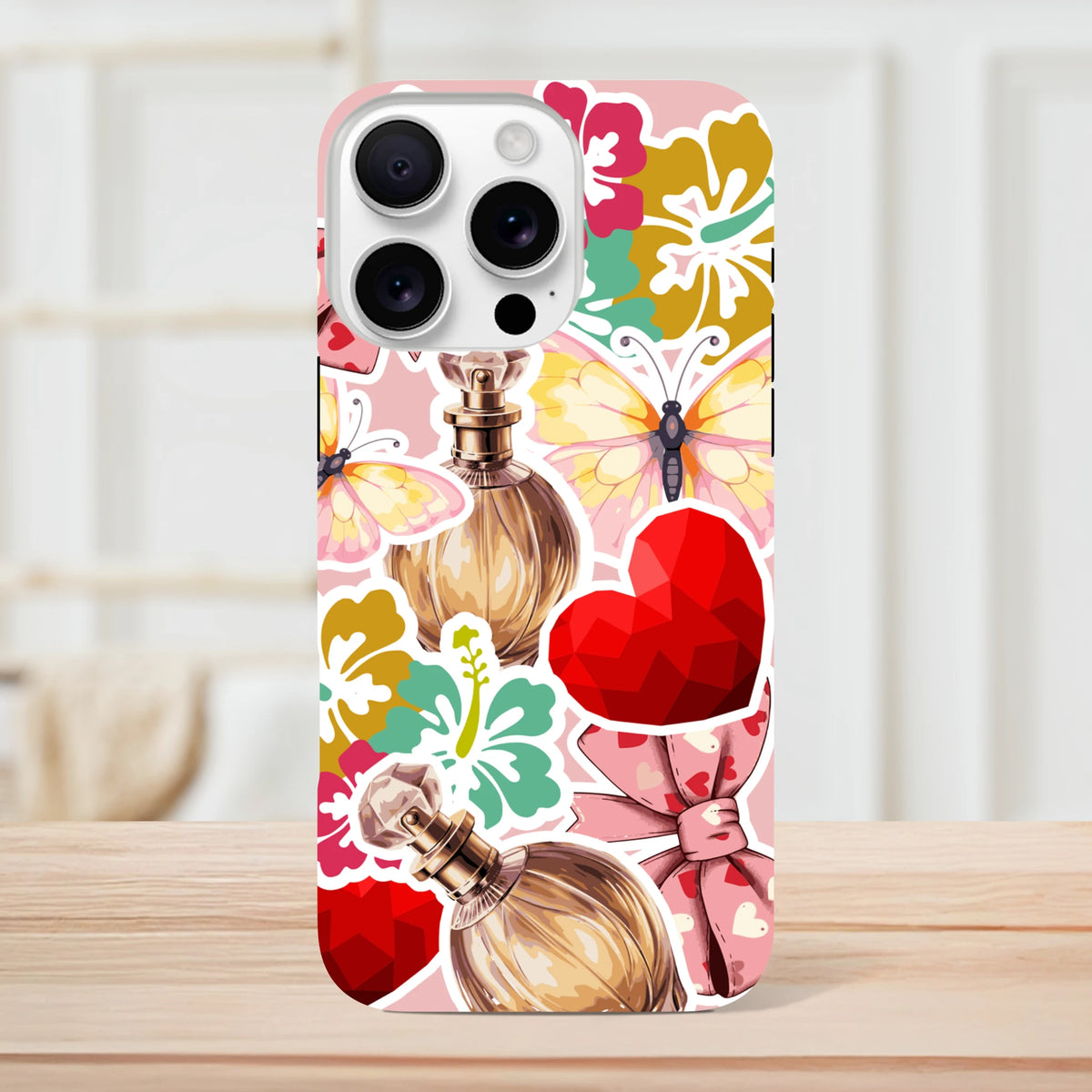 Pink floral perfume sticker effect iPhone case featuring butterfly graphics, red heart, and bold streetwear aesthetics for tough protection.