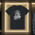 Black t-shirt with white graphic design on a clothing rack.