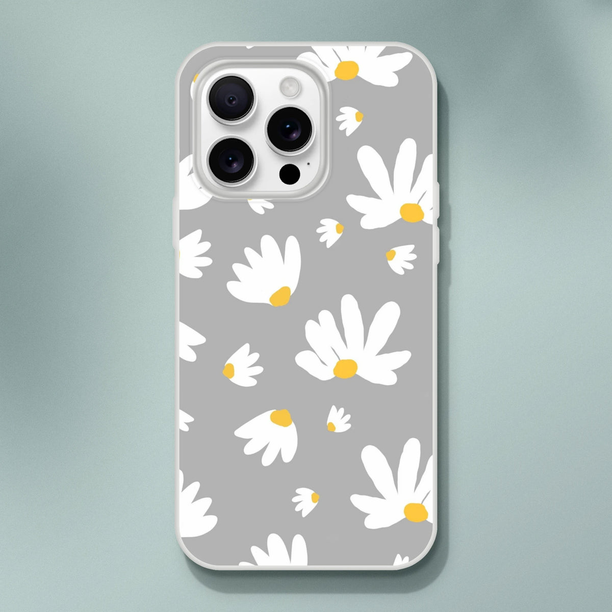 Ditsy Daisy iPhone case (13-16) with gray background and white daisies with yellow centers.