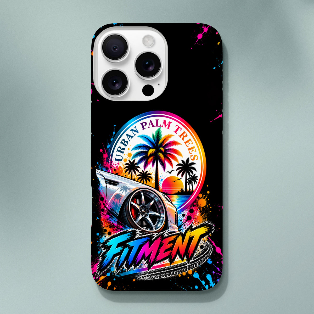 Fitment iPhone case featuring modified car, colorful Urban Palm Trees sunset graphic, and gloss streetwear paint splatter design.