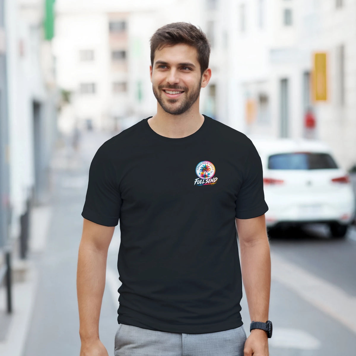 Man wearing black modified car culture graphic tee with colorful Full Send palm tree logo on chest for streetwear.