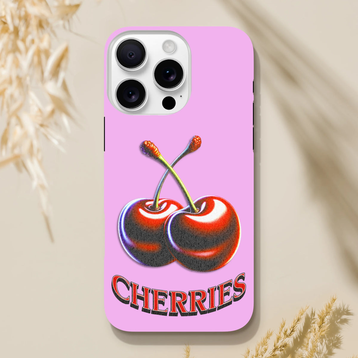 Retro pink iPhone case featuring a Y2K-style glossy cherry illustration and bold "CHERRIES" text for durable everyday protection.